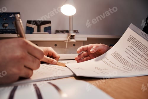 Preview: Closeup shot of people's hands at a meeting with one person signing business papers