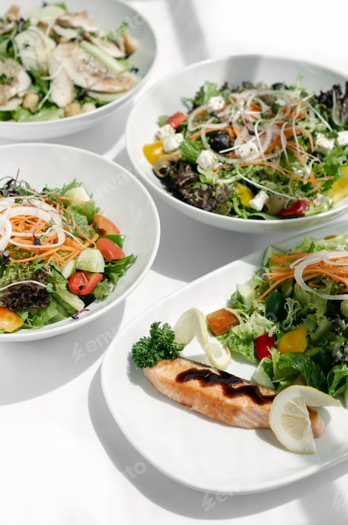 Preview: mixed fresh organic salads on white restaurant table