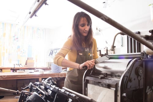 Preview: Woman preparing printer in shop
