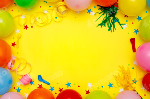 Preview: Colorful balloons and confetti on yellow table top view. Festive or party background.