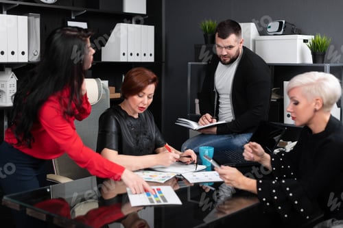 Preview: Smiling employees talking in workplace