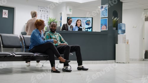Preview: African american man and woman talking about disease in hospital reception