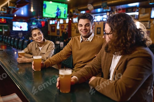 Preview: Group of happy friends resting and talking at bar or pub