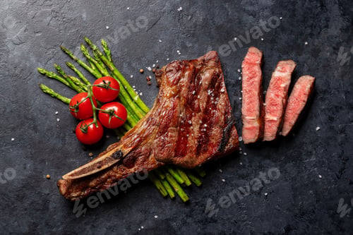 Preview: Medium rare grilled Tomahawk beef steak with asparagus