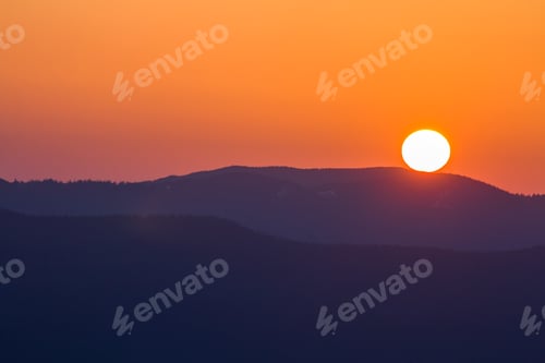 Preview: Fantastic wide panorama view of big bright white sun in dramatic orange sky