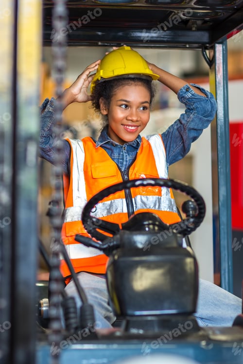 Preview: women worker at forklift driver happy working in industry factory logistic ship