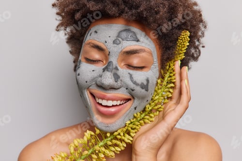 Preview: Woman with Clay Mask and Flowers Smiling