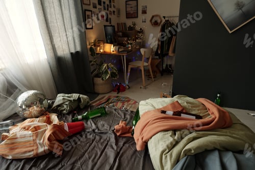 Preview: Creased clothes and empty bottles on bed