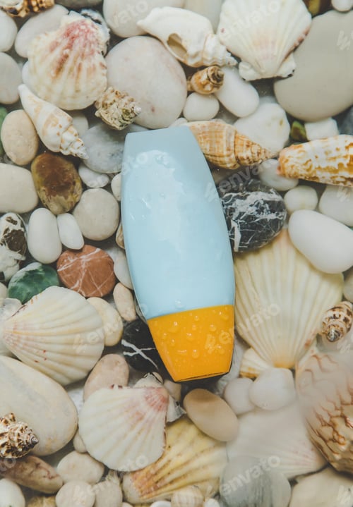 Preview: Sunscreen on the background of sea stones. Selective focus.