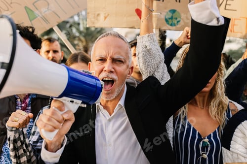 Preview: Senior activist man with a megaphone leading protest against climate change