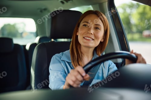 Preview: Happy businesswoman traveling by car and looking away.