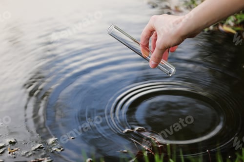 Preview: Scientist and biologist hydro-biologist takes water samples for analysis. Hand is collects water
