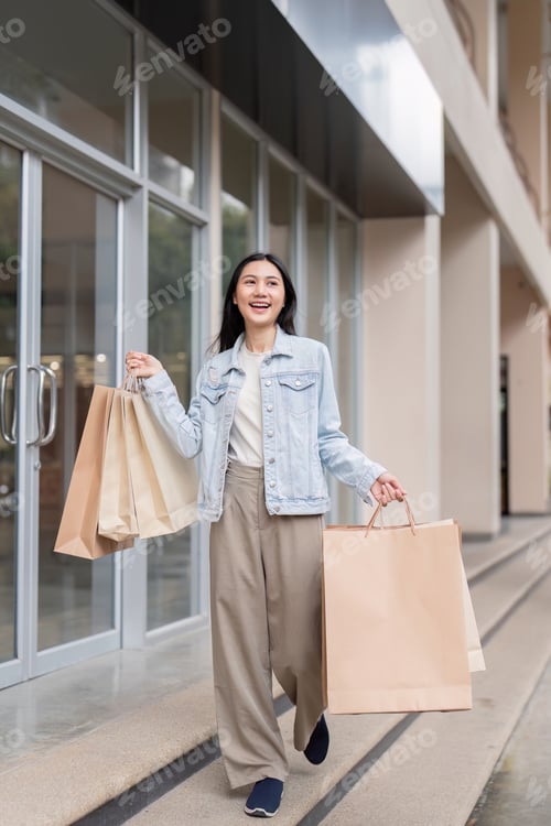 Preview: Happy Shopper Holding Large Bags After Successful Black Friday Shopping