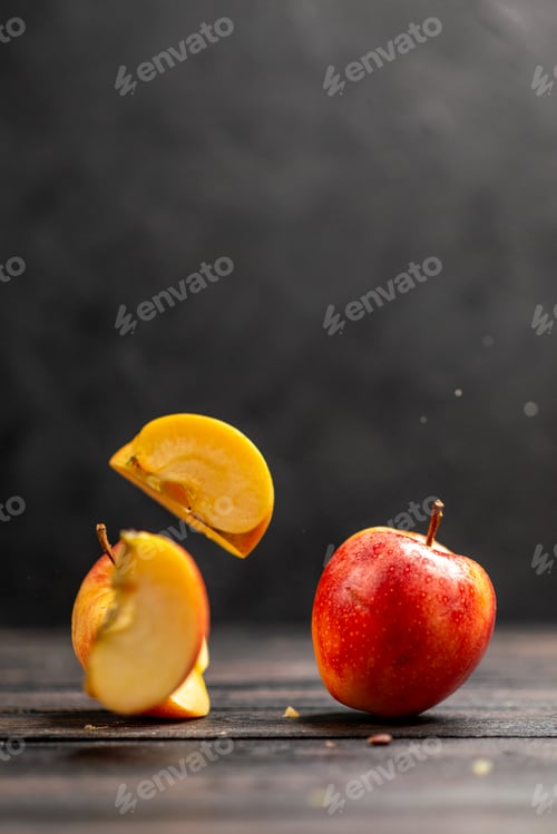 Preview: Vertical view of fresh natural chopped and whole red apples on black background