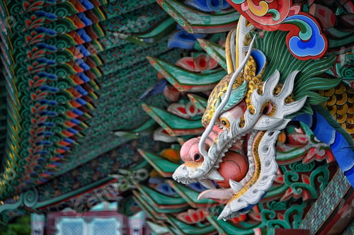 Preview: Selective focus of the colorful wooden dragon face on the Jangyu temple in Gimhae, South Korea