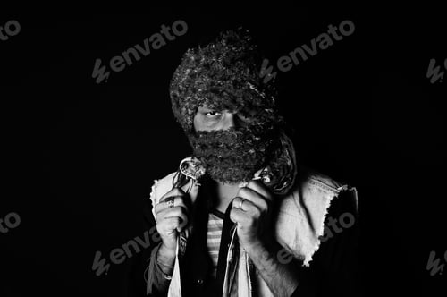 Preview: Grayscale portrait of a South Asian male in long headwear on a dark background