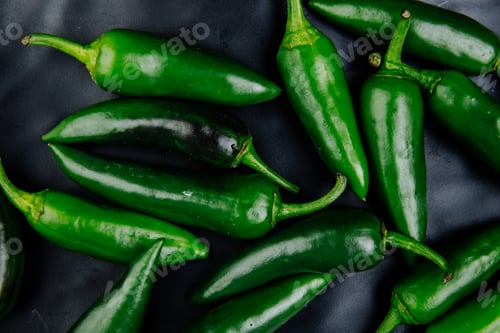 Preview: top view of fresh green chili peppers on black background