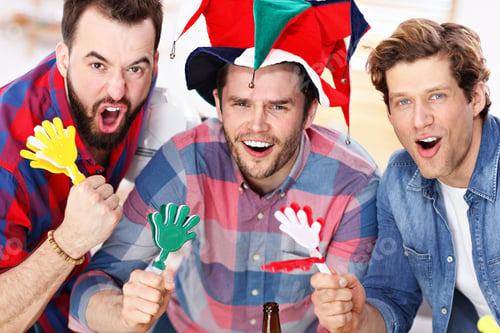 Preview: Happy male friends cheering and watching sports on tv