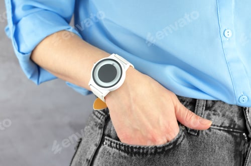 Preview: Beautiful white wrist watch on a female hand, close-up