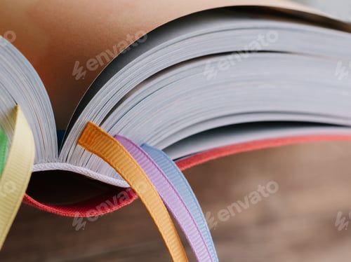 Preview: Closeup of the back of a book with colored bookmarks.
