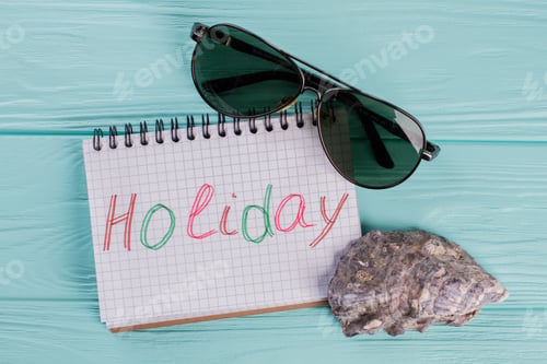 Preview: Trendy aviator sunglasses and tropical seashell on textured wooden background.