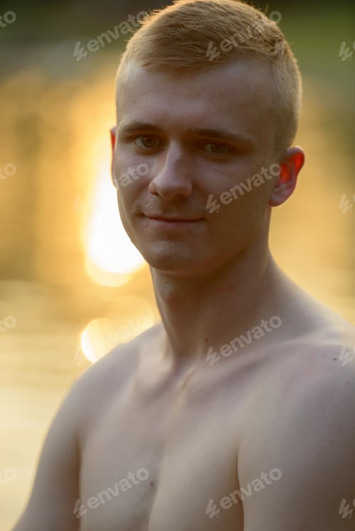 Preview: Young man with blond hair shirtless at the park outdoors