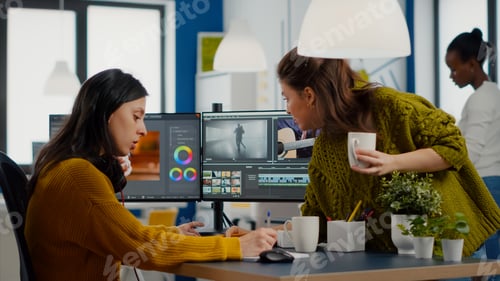Preview: Colleagues discussing about video project adjusting film footage