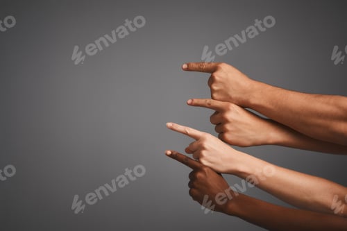 Preview: Studio shot of unidentifiable hands pointing upwards towards blank copyspace