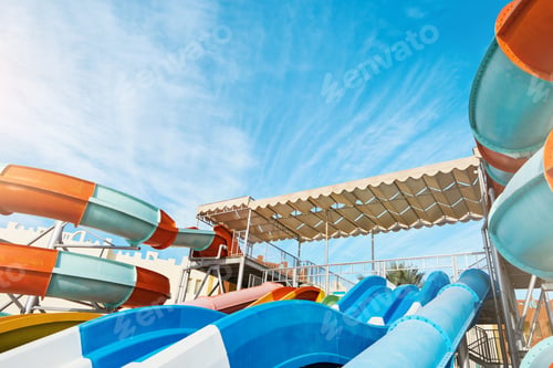 Preview: Water park with water colored flights, slides, splashes and pools at luxury hotel. summer vacation a