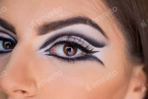 Preview: Portrait of a young brunette female model with dark eyeliner