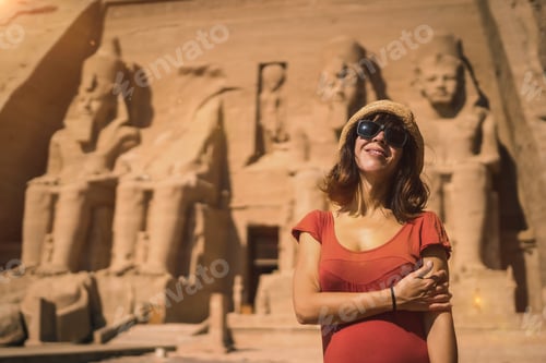 Preview: A young tourist in red dress at the Abu Simbel Temple in southern Egypt in Nubia