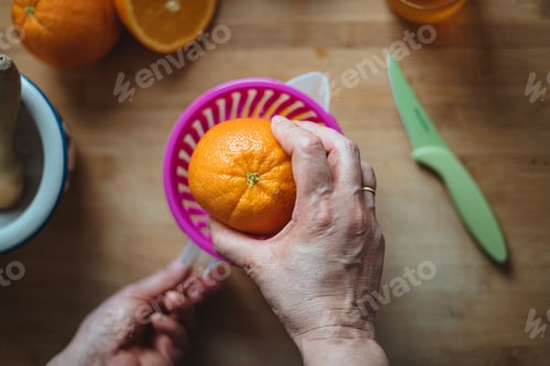 Preview: Woman squeezing orange.