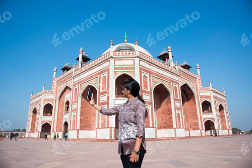 Preview: Young girl taking Photos in front of Humayun's Tomb, Delhi, India.