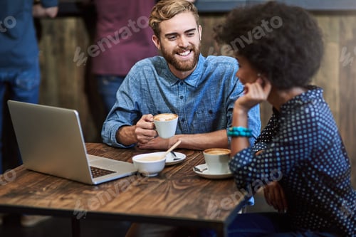 Preview: Catching up over coffee. Shot of two people sitting in a cafe, drinking coffee.