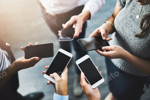 Preview: Closeup shot of a group of businesspeople using their cellphones in synchronicity