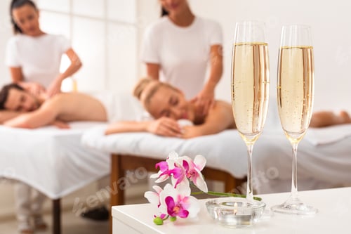 Preview: Couple Enjoying Massage, Spa Composition With Champagne Flutes And Flowers