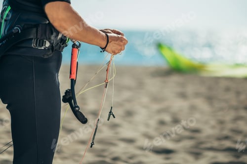 Preview: Woman using flying lines and a control bar for kitesurfing