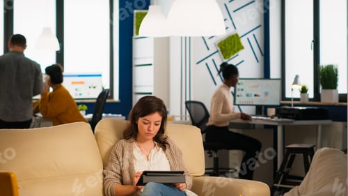 Preview: Diverse employees working in modern strat up office in cozy decor