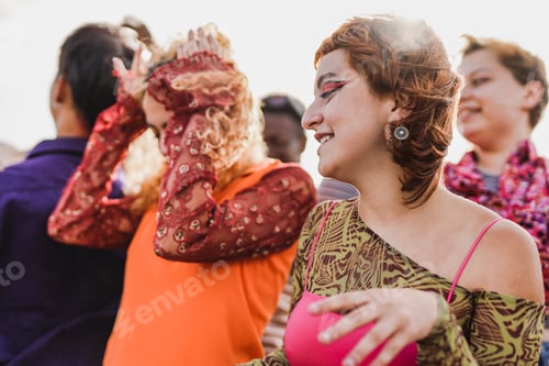 Preview: Group of diverse young people dancing at concert outdoor