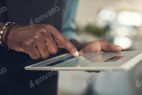 Preview: Cropped shot of an unrecognizable man standing alone in his bicycle shop and using a digital tablet