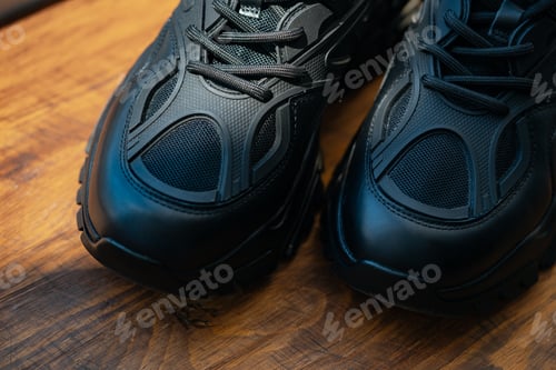 Preview: Close up of black sport shoes on wooden background