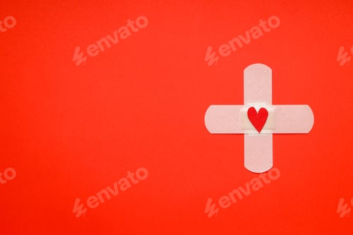 Preview: Bandage adorned with a red heart on a red background