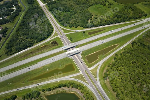Preview: Aerial view of freeway overpass junction with fast moving traffic cars and trucks.