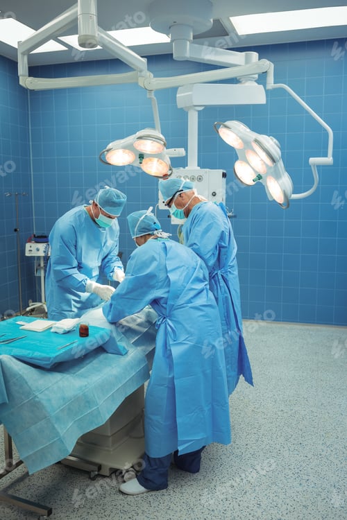 Preview: Team of surgeons performing operation in operation theater