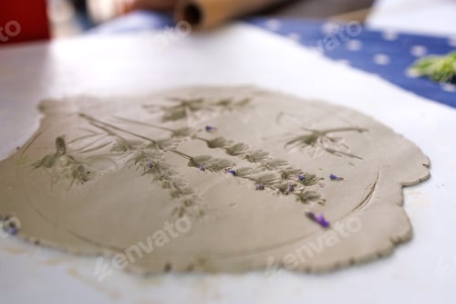 Preview: Creation of stencil ceramics with flowers, leaves of lavender and other plants by pressing on table