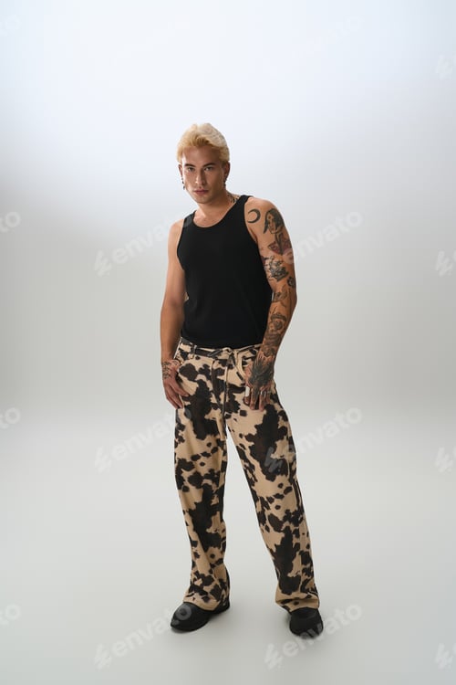 Preview: Confident young man showcases unique style with trendy cow print fashion