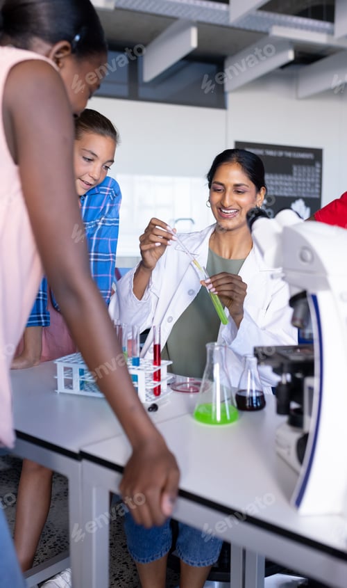 Preview: Conducting science experiment with test tubes and beakers, students in school laboratory