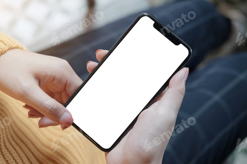 Preview: Top view Woman sitting and holding blank screen mock up mobile phone