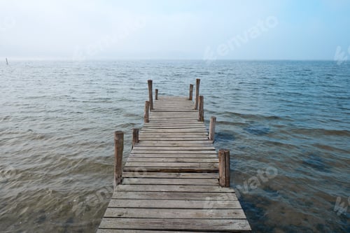 Preview: Wooden jetty on lake in a foggy mood.