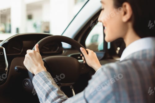 Preview: Young caucasian woman driving her new car